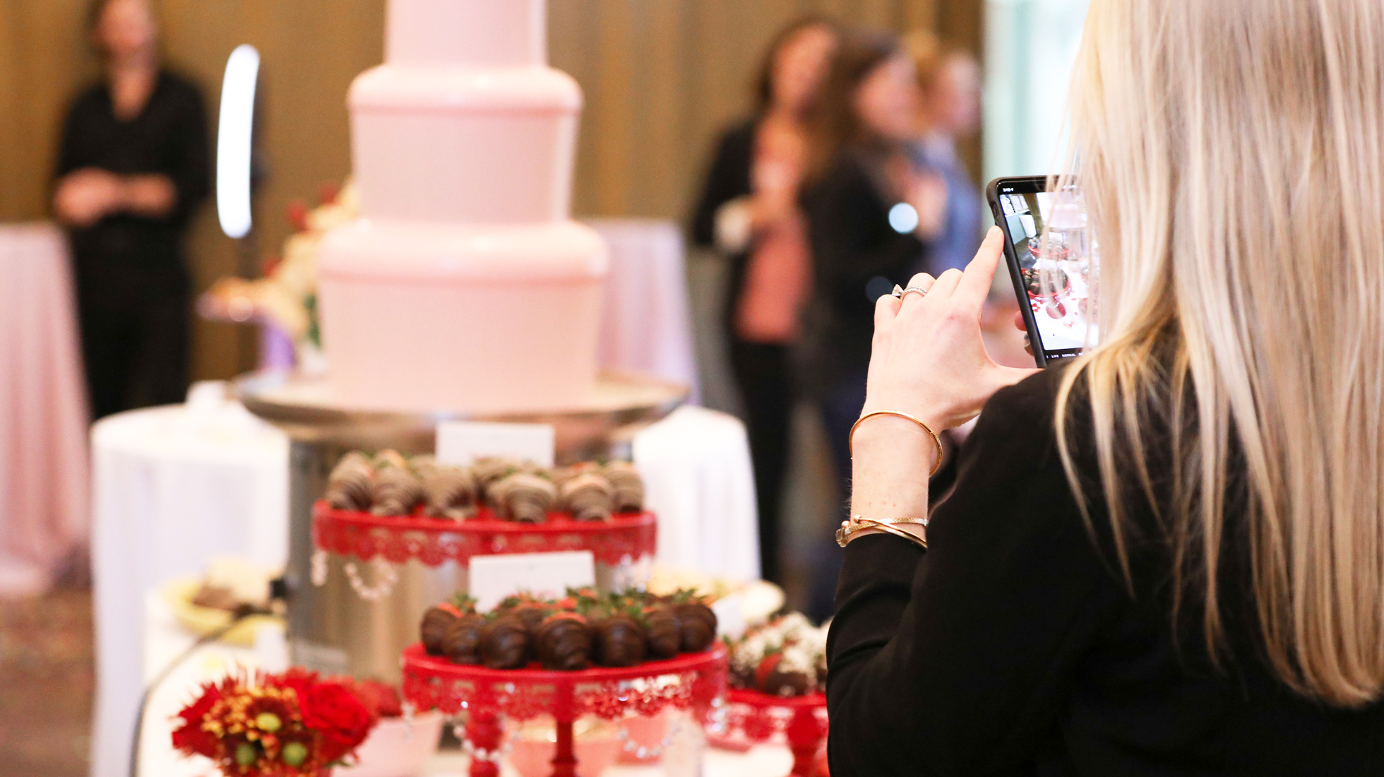 Woman taking a photo at Edible's 20th birthday experience