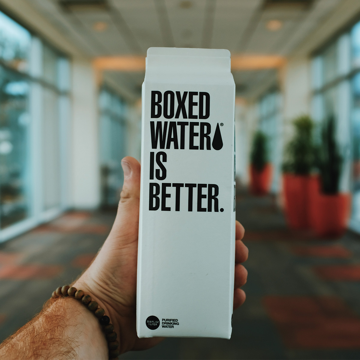 Person holding boxed water