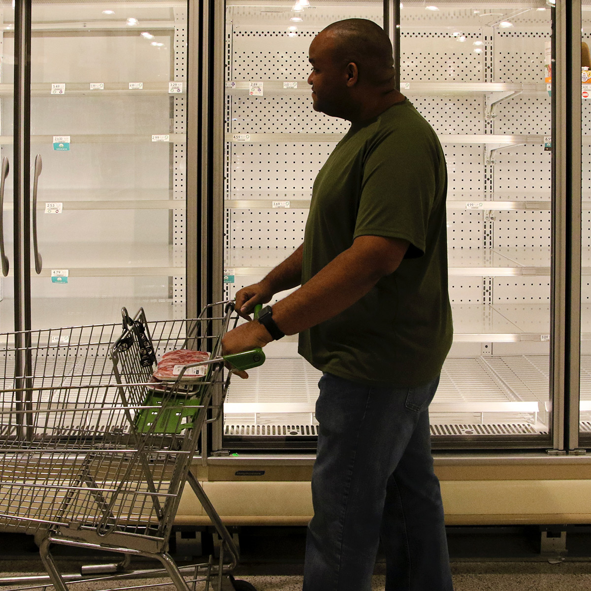 Man shopping in empty freezer section