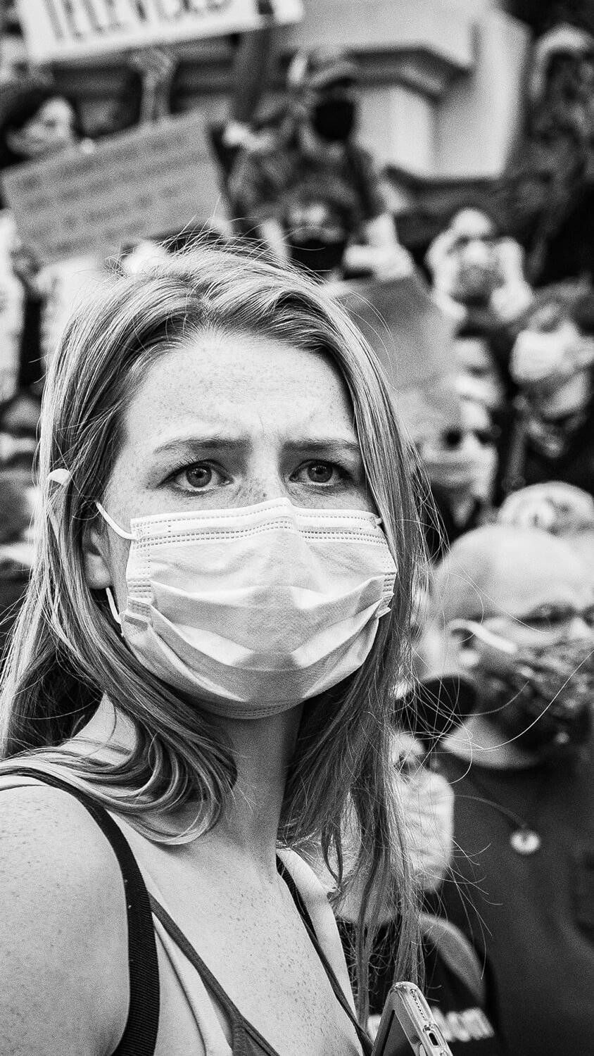 Woman wearing mask at protest
