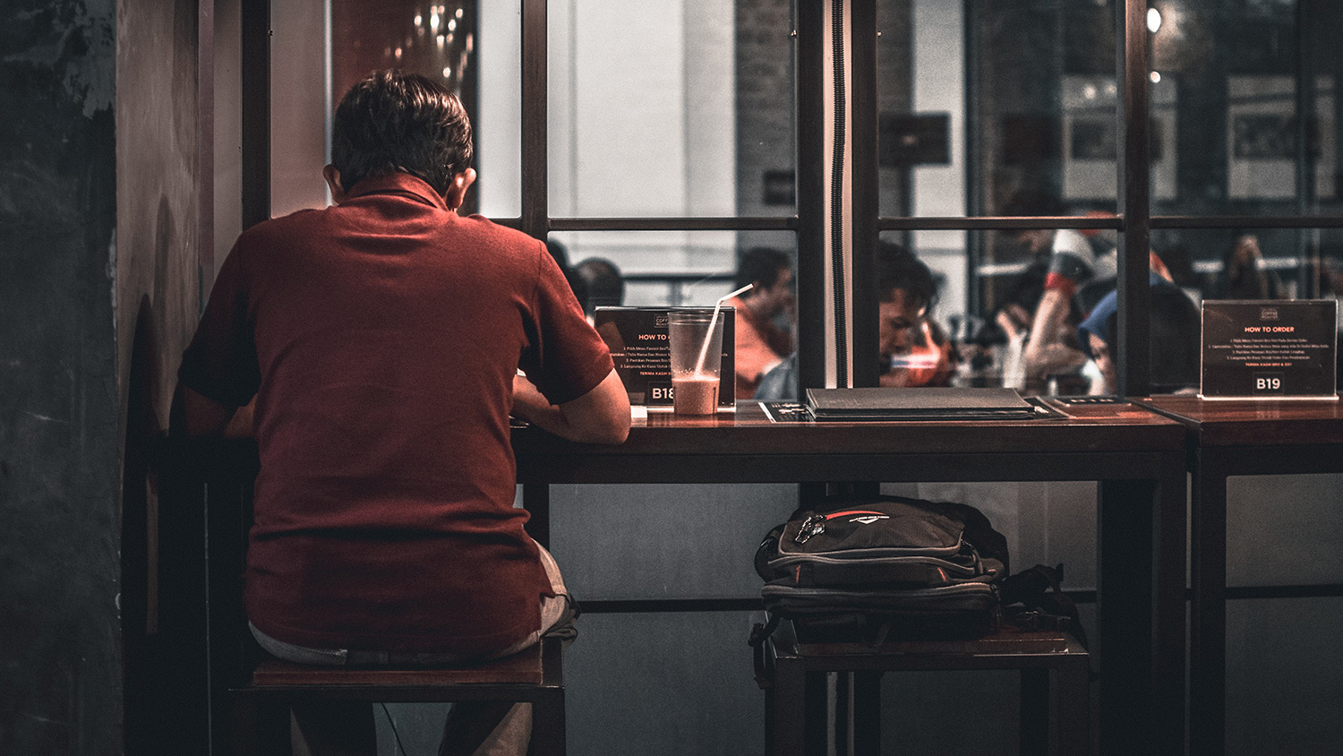 Man sitting at cafe alone